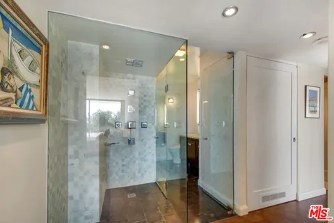 a bathroom with a glass shower door and a sink