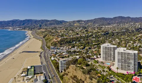 a view of swimming pool with outdoor seating and city view