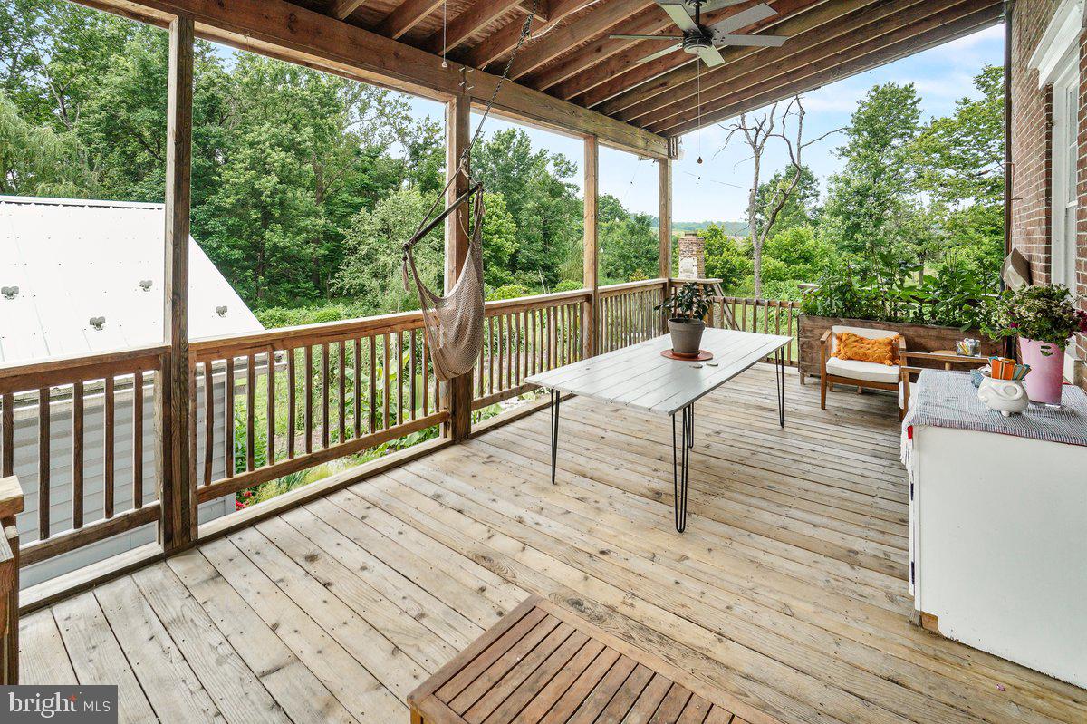 1498 Mckinstrys Mill Road Union Bridge, MD 21791 - Photo 37 of 54 a balcony with wooden floor and outdoor seating