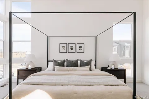 a bedroom with a large bed and a night stand