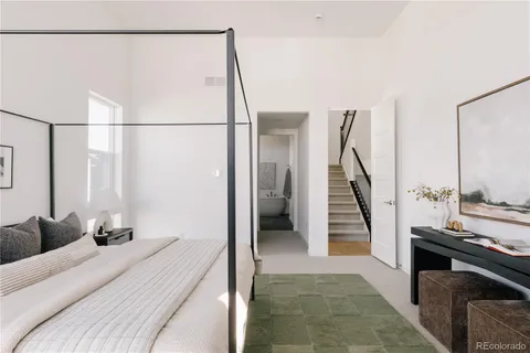 a bed room with a bed and a television