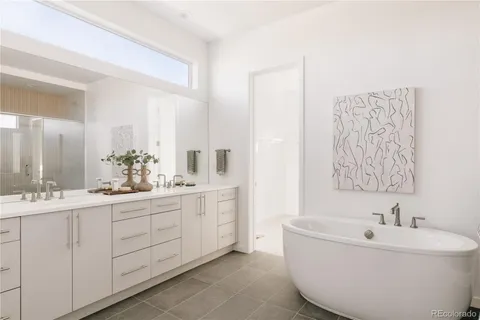 a bathroom with a bathtub sink and mirror