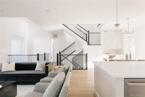 a living room with furniture and a view of kitchen