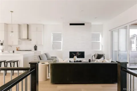 a living room with furniture and large windows