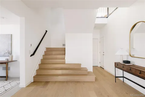 a view of entryway and hall with wooden floor