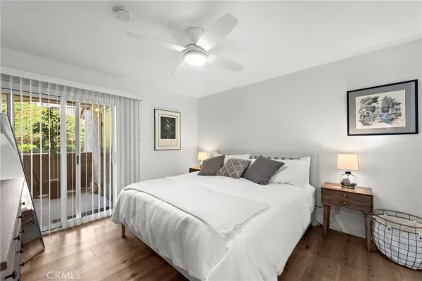 a bedroom with a bed and a large window