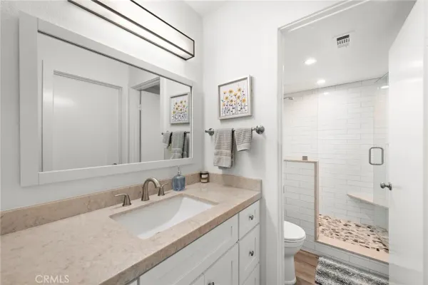 a bathroom with a sink toilet and shower