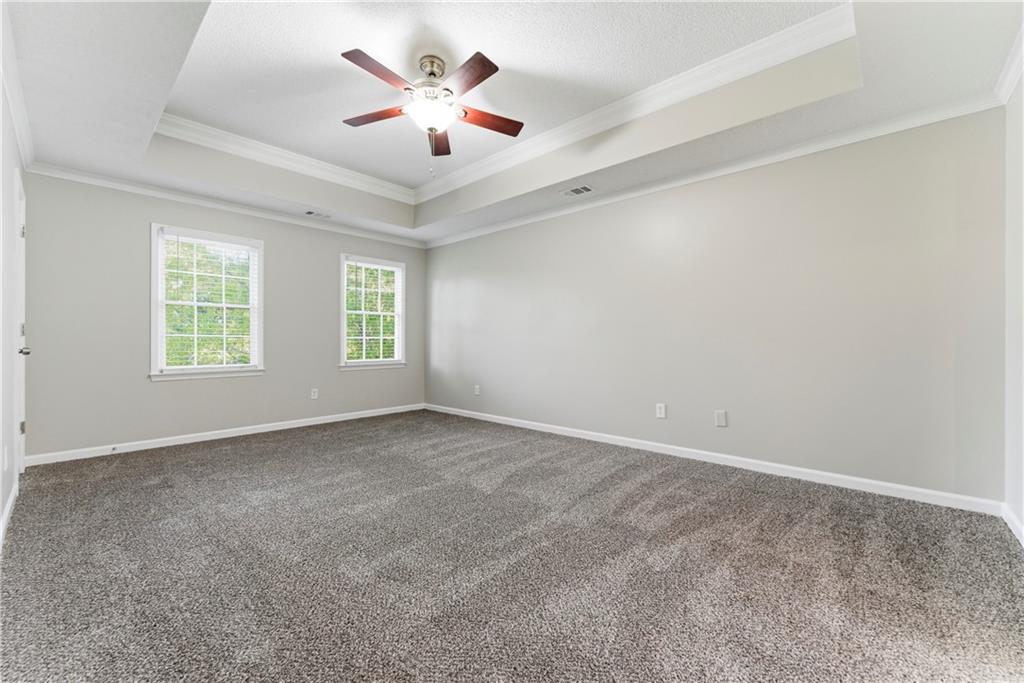 1043 Sterling Ridge Chase Northeast Marietta, GA 30062 - Photo 11 of 14 an empty room with windows and fan