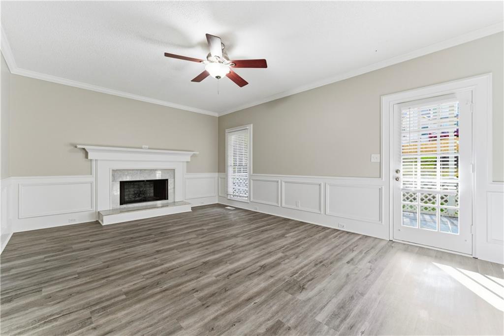 1043 Sterling Ridge Chase Northeast Marietta, GA 30062 - Photo 5 of 14 a view of an empty room with wooden floor fireplace and a window