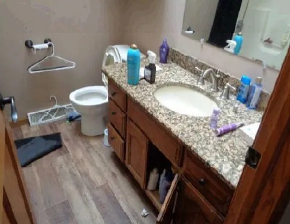a bathroom with a granite countertop sink and a mirror