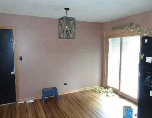 a view of a bedroom with a bed and a window