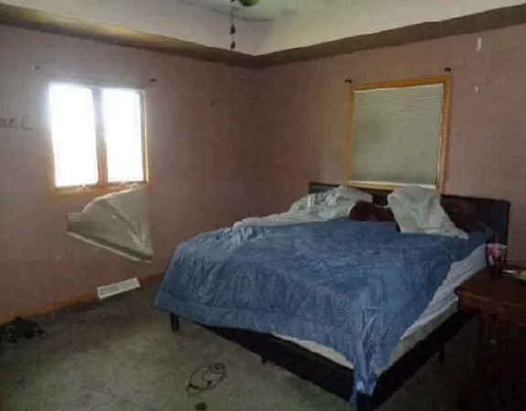 a bedroom with a bed and window