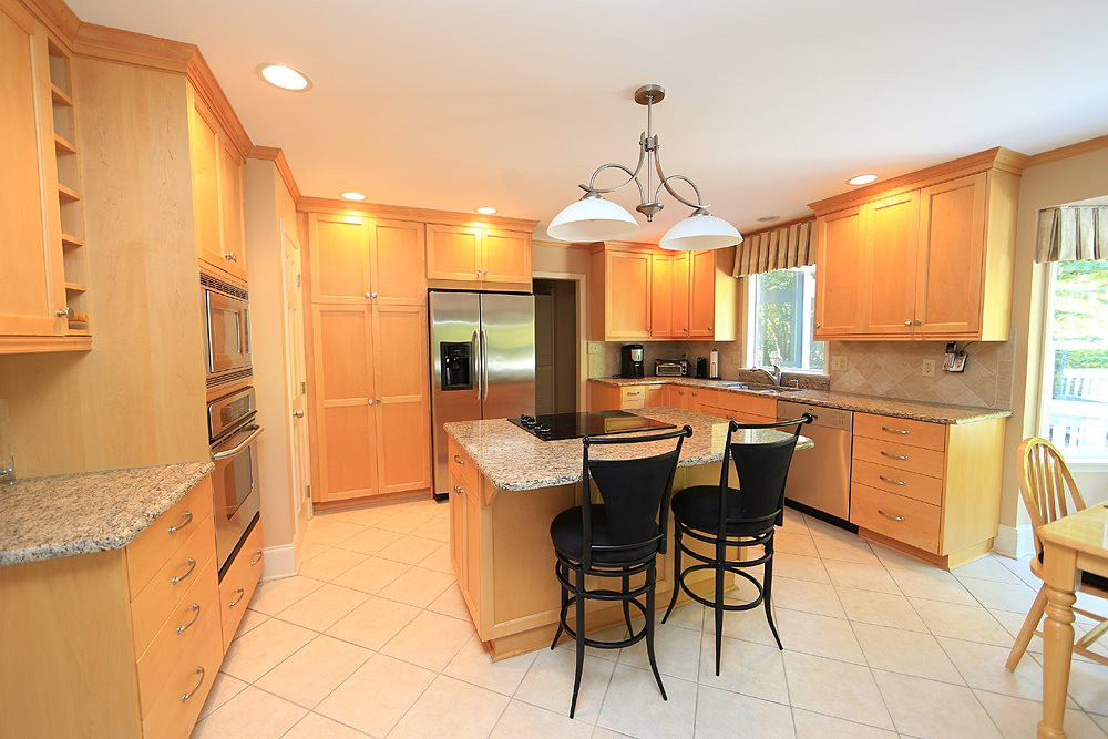 7905 Hardwick Drive Raleigh, NC 27615 - Photo 4 of 26 Remodeled kitchen features quality light wood cabinetry, center island, pantry with pull out shelving, tons of storage. Kitchen