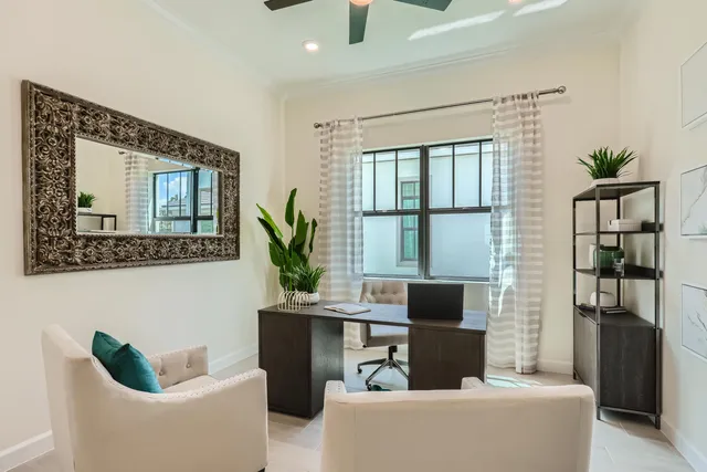 a living room with furniture and a potted plant