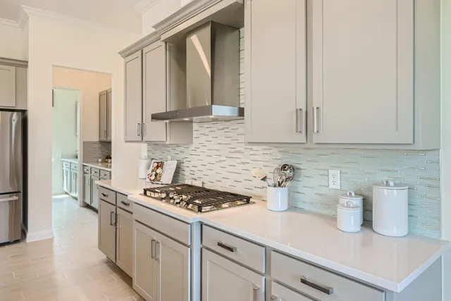 a kitchen with stainless steel appliances granite countertop a sink a stove and a refrigerator