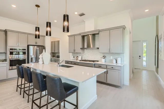a kitchen with stainless steel appliances kitchen island granite countertop a sink and cabinets