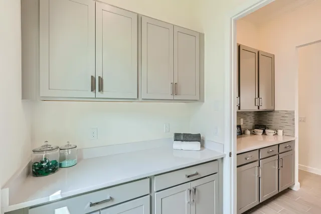 a kitchen with stainless steel appliances white cabinets and white appliances