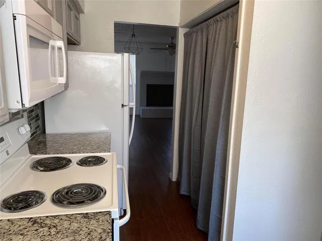 a kitchen with a refrigerator and a stove