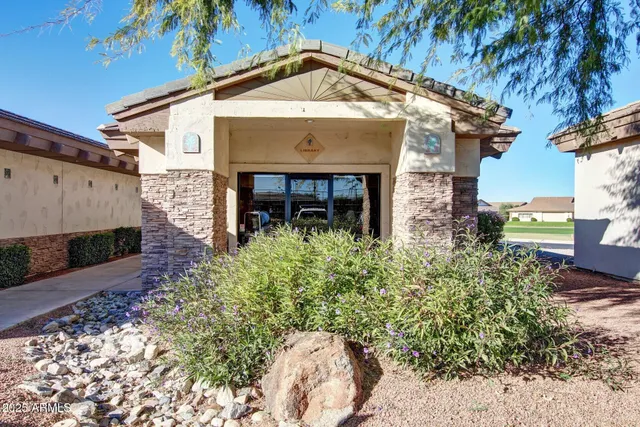a room with stainless steel appliances kitchen island a table and chairs