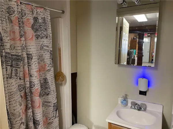 a bathroom with a sink toilet and shower