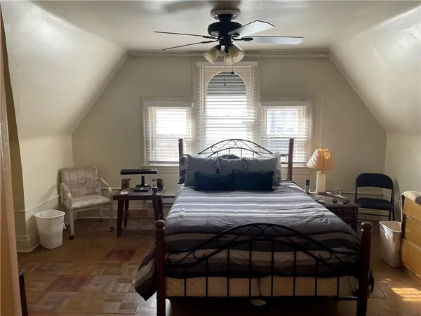 a bedroom with a bed and a lamp
