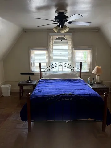a view of a room with wooden floor and a window