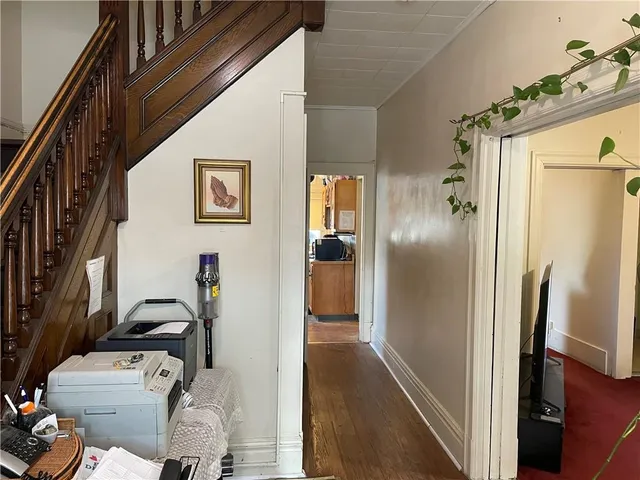 a hallway with furniture and a refrigerator