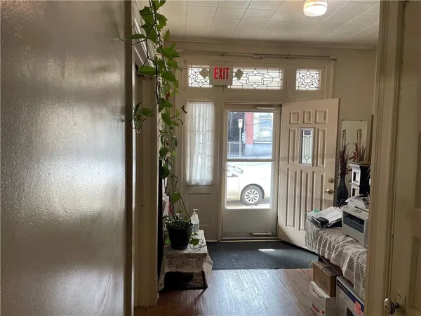 a view of an entryway door with a living room