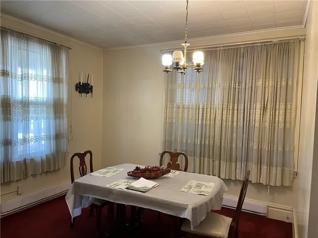 a view of a dining room with furniture and chandelier