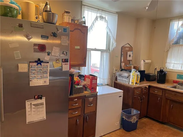 a kitchen with sink refrigerator and cabinets