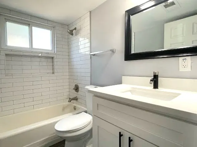 a bathroom with a sink a toilet and a bathtub
