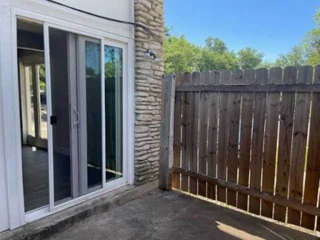 a view of a wooden door with a small yard