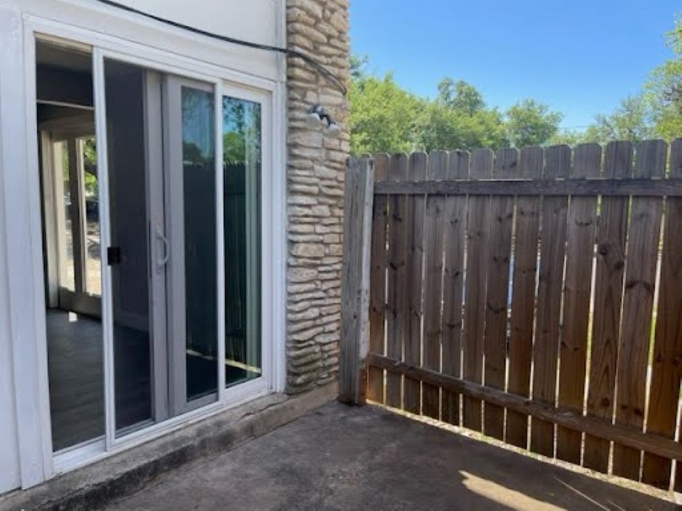 2504 Manor Circle, Unit A Austin, TX 78723 - Photo 16 of 17 a view of a wooden door with a small yard