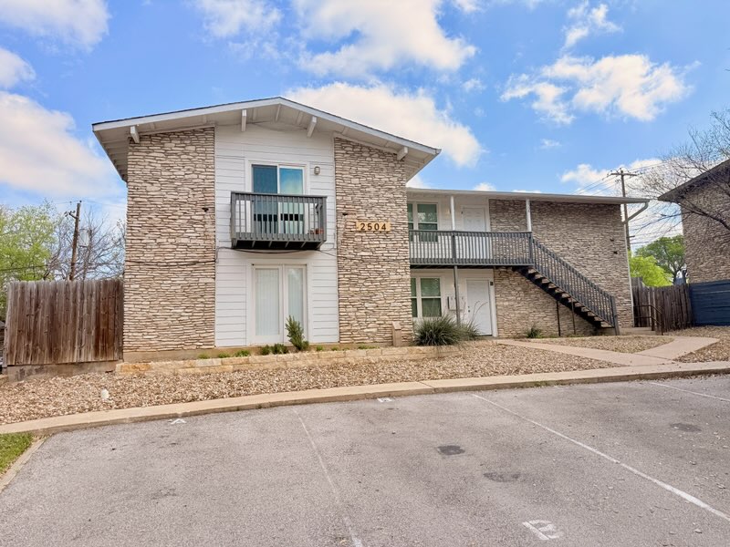 2504 Manor Circle, Unit A Austin, TX 78723 - Photo 3 of 17 a front view of a house with a yard