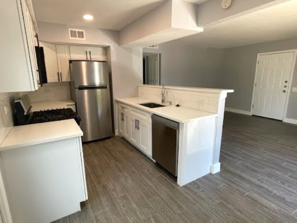 2504 Manor Circle, Unit A Austin, TX 78723 - Photo 5 of 17 a kitchen that has a sink and a refrigerator