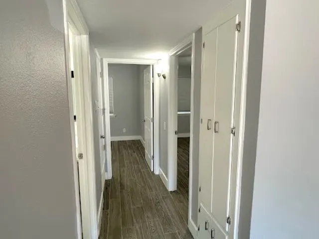 a view of a hallway with wooden floor