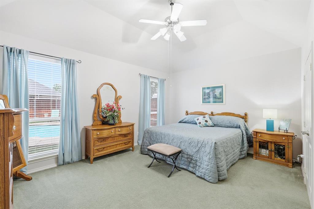 2321 Bear Run Road Arlington, TX 76001 - Photo 15 of 34 a bedroom with a bed and a chandelier