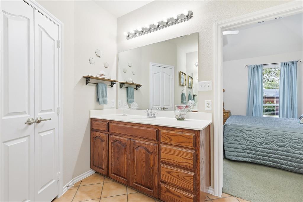2321 Bear Run Road Arlington, TX 76001 - Photo 18 of 34 a bathroom with a sink double vanity and a mirror