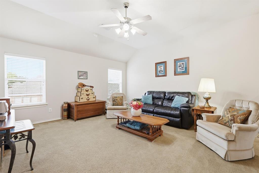2321 Bear Run Road Arlington, TX 76001 - Photo 22 of 34 a living room with furniture and a chandelier