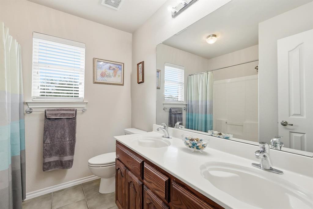 2321 Bear Run Road Arlington, TX 76001 - Photo 26 of 34 a bathroom with a sink toilet and shower