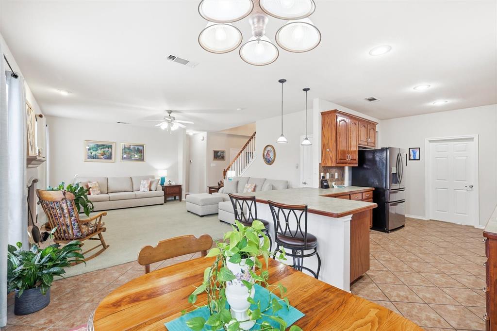 2321 Bear Run Road Arlington, TX 76001 - Photo 8 of 34 a living room with furniture kitchen view and a chandelier