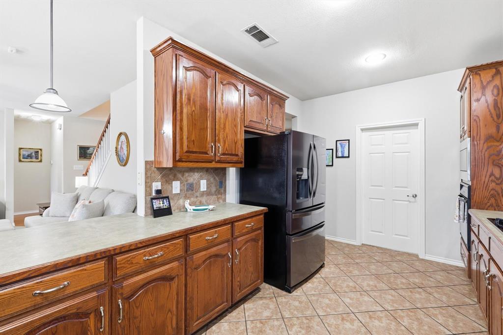 2321 Bear Run Road Arlington, TX 76001 - Photo 9 of 34 a kitchen with stainless steel appliances granite countertop a refrigerator and a sink