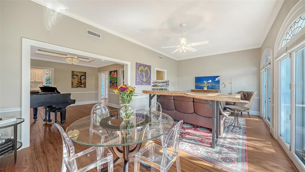 57 Bishopscourt Road, Unit 121 Osprey, FL 34229 - Photo 15 of 86 a view of a dining room with furniture and wooden floor