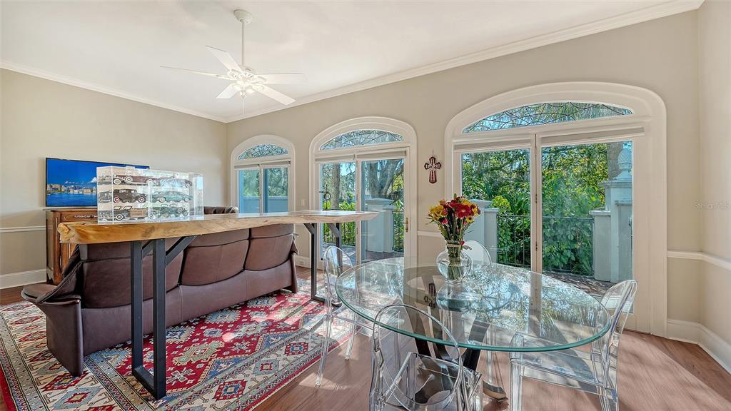 57 Bishopscourt Road, Unit 121 Osprey, FL 34229 - Photo 20 of 86 a dining room with furniture a chandelier and wooden floor