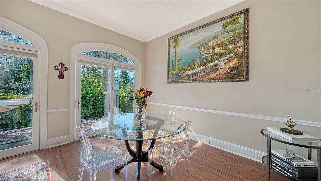 57 Bishopscourt Road, Unit 121 Osprey, FL 34229 - Photo 21 of 86 a view of a dining room with furniture window and wooden floor