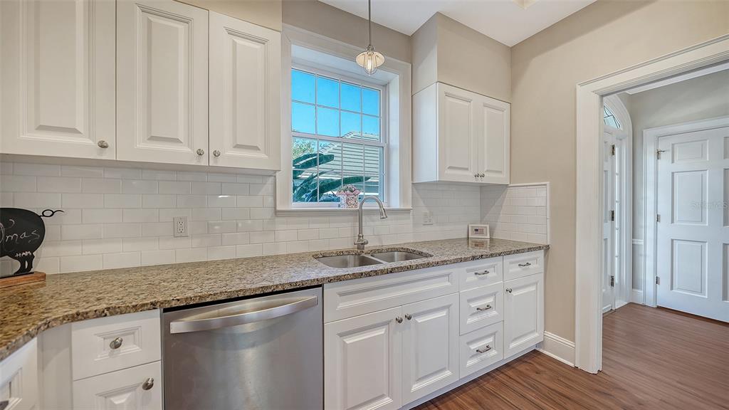 57 Bishopscourt Road, Unit 121 Osprey, FL 34229 - Photo 27 of 86 a kitchen with stainless steel appliances granite countertop a sink a stove and cabinets