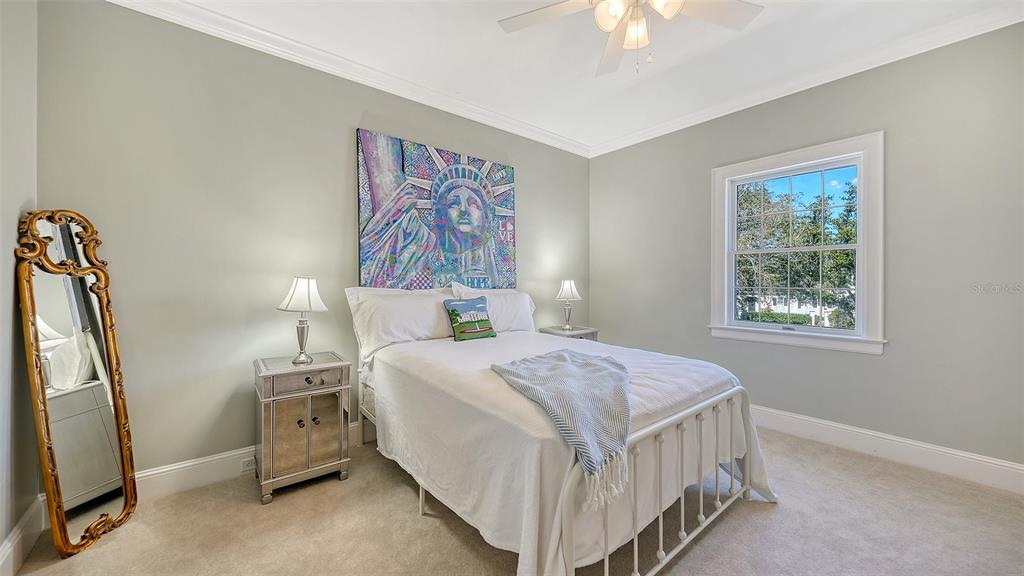 57 Bishopscourt Road, Unit 121 Osprey, FL 34229 - Photo 31 of 86 a bedroom with bed and a chandelier