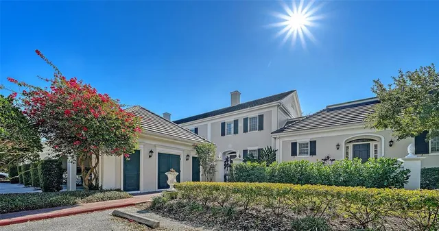 a living room with furniture a chandelier and a dining table