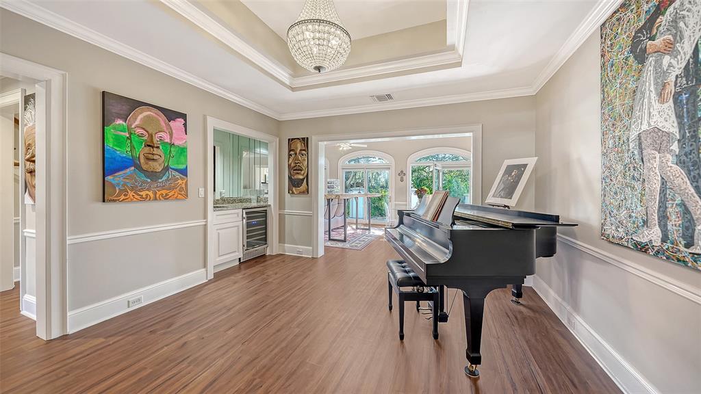 57 Bishopscourt Road, Unit 121 Osprey, FL 34229 - Photo 10 of 86 a view of a dining room with furniture a chandelier and wooden floor