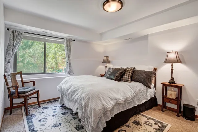 a bedroom with a bed and a table in it